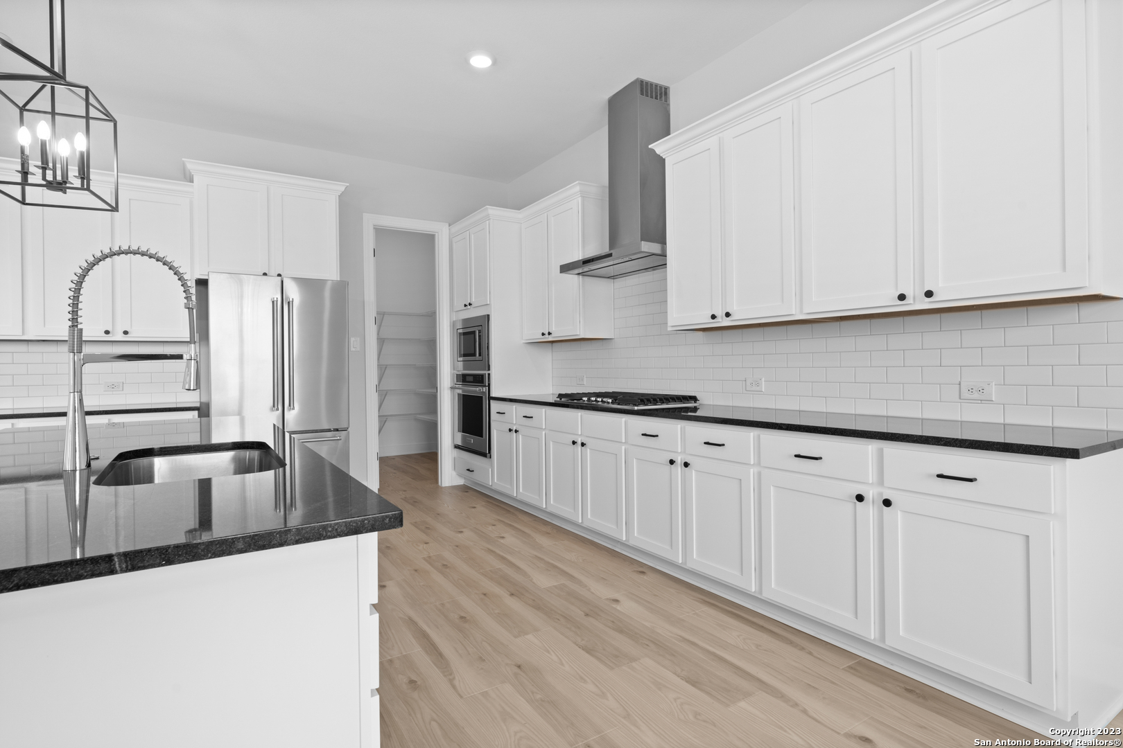 174 Azalea Alley Castroville, TX 78009 - Photo 8 of 22 a kitchen with granite countertop white cabinets and sink
