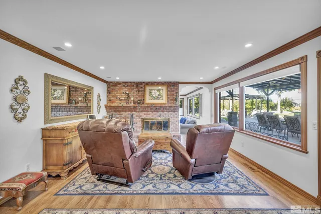 a living room with furniture and a floor to ceiling window