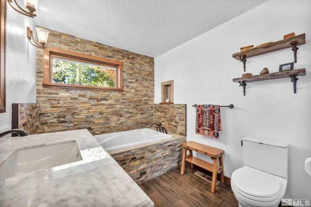 a bathroom with a toilet a sink and bathtub