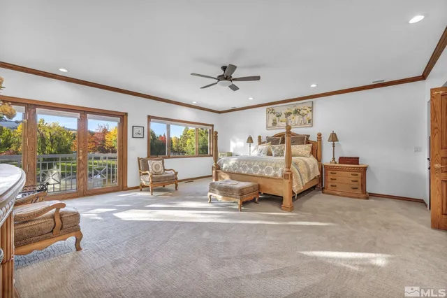 a living room with a bed furniture and a large window