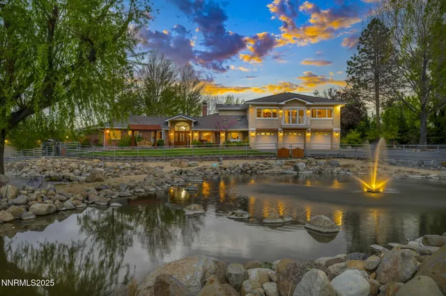a front view of a house with a lake view