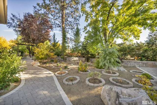 a view of a house with a yard and potted plants