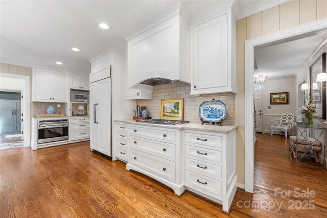 a kitchen with stainless steel appliances a stove a sink and a refrigerator