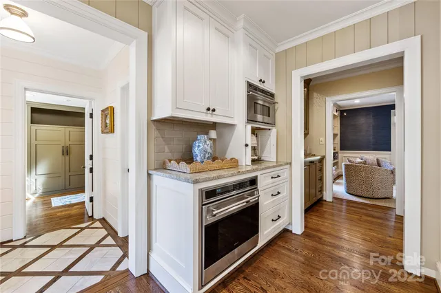 a kitchen with a stove and white cabinets