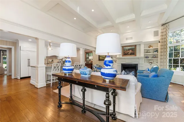 a living room with furniture a fireplace and a table