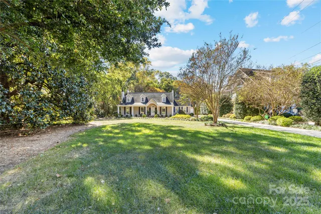 a view of yard with swimming pool and green space