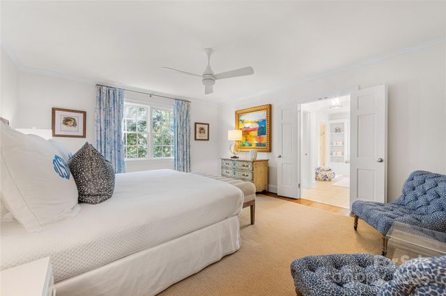 a bedroom with a bed a couch and a window