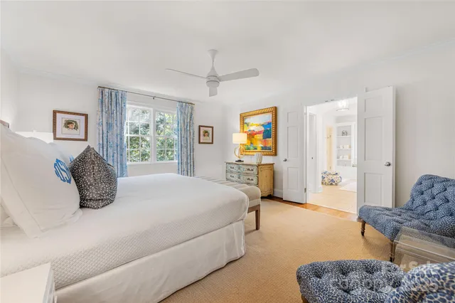 a bedroom with a bed a couch and a window