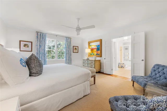 a bedroom with a bed a couch and a window