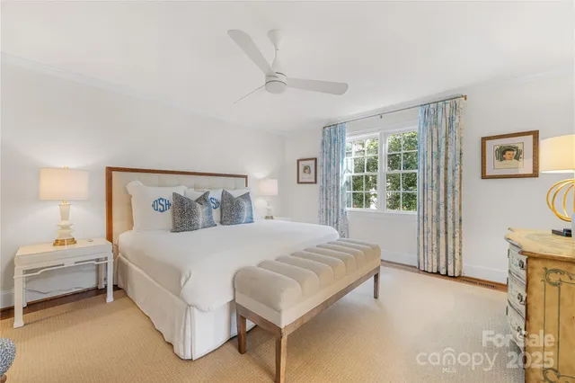 a bedroom with a bed lamp and a window