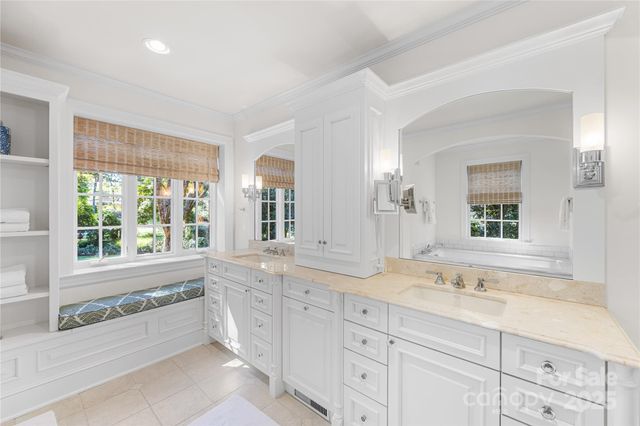 a spacious bathroom with double vanity and a large mirror