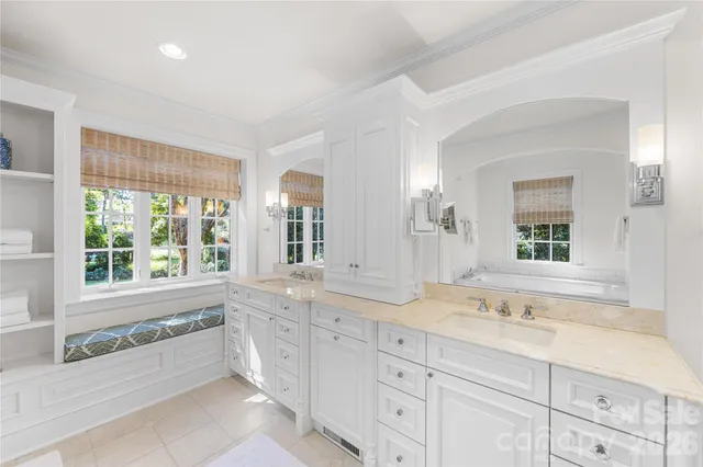 a spacious bathroom with double vanity and a large mirror