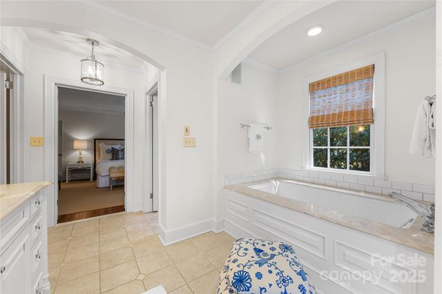 a spacious bathroom with a tub and a shower