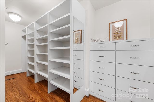 a view of walk in closet with empty racks