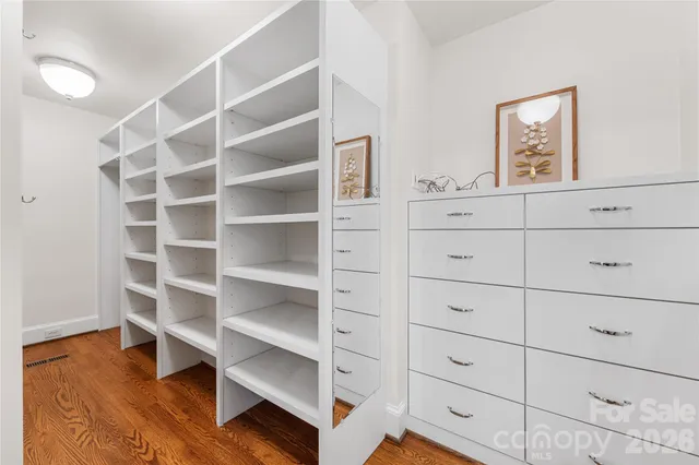 a view of walk in closet with empty racks