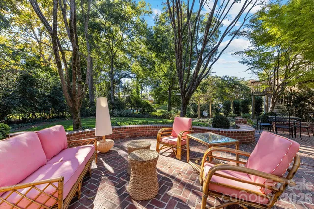 a view of a patio with a table chairs and a fire pit