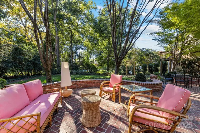 a view of a patio with a table chairs and a fire pit