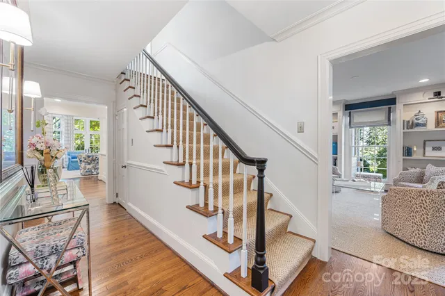 a view of entryway and hall with wooden floor