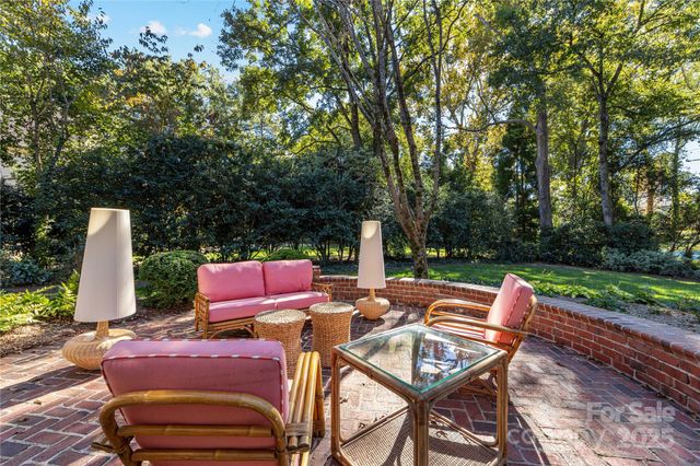 a view of backyard with seating area and green space