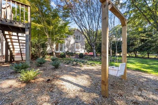 a view of a house with backyard and a tree