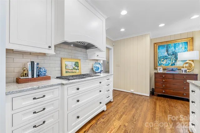 a kitchen with granite countertop white cabinets and white appliances