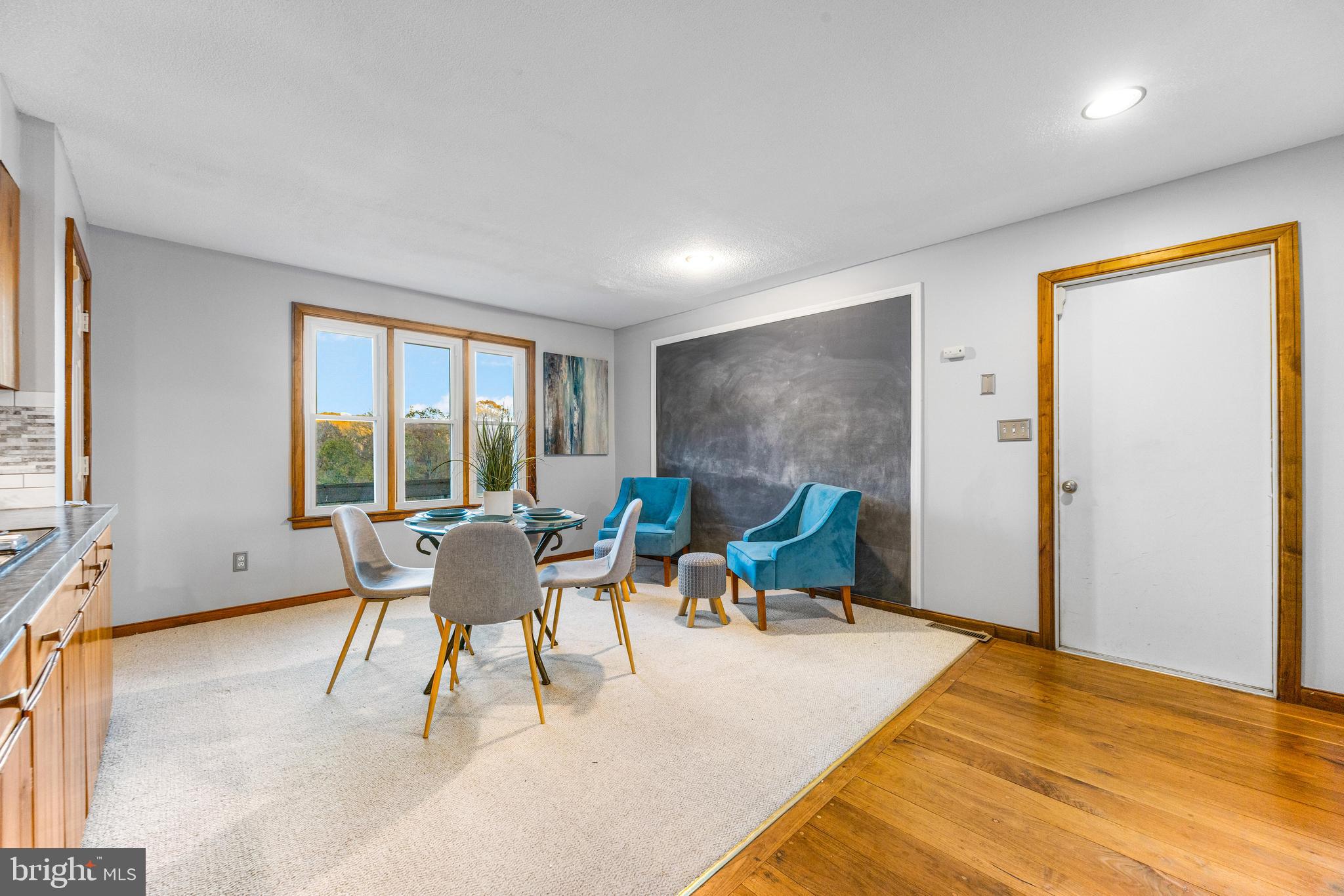 1763 Gablehammer Road Westminster, MD 21157 - Photo 12 of 51 a dining room with furniture a flat screen tv and a floor to ceiling window