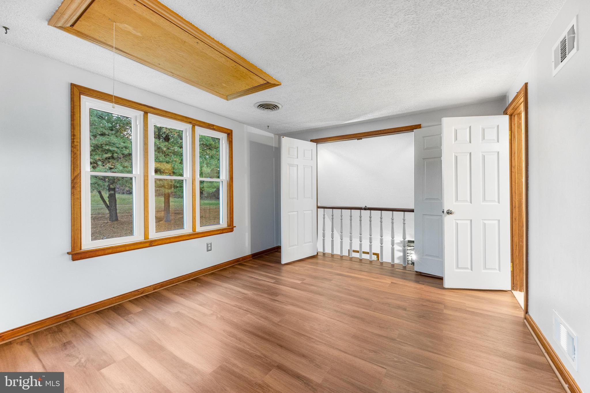 1763 Gablehammer Road Westminster, MD 21157 - Photo 23 of 51 a view of an empty room with wooden floor and a window