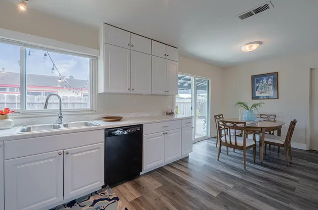 a kitchen with a sink stove and white cabinets