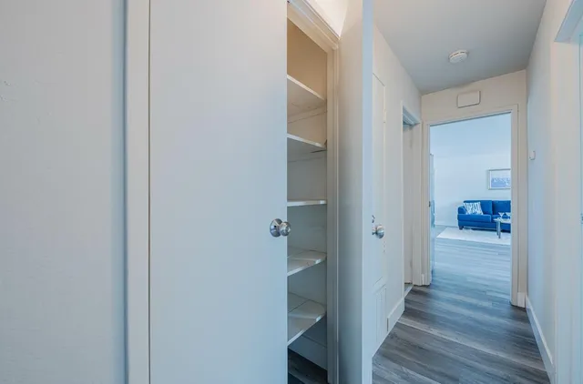 a view of a hallway with wooden floor