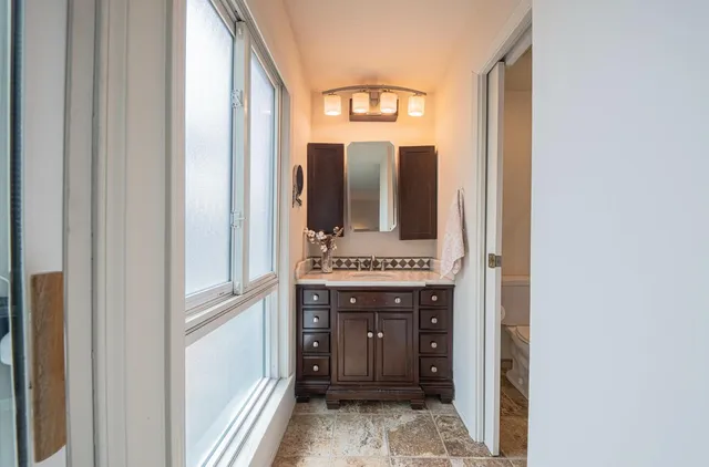 a bathroom with a mirror and a sink