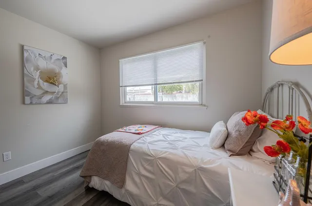 a bedroom with a bed and a window