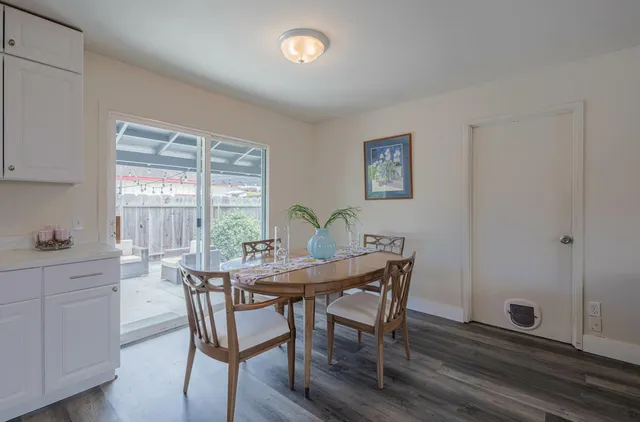 a view of a dining room with furniture and window