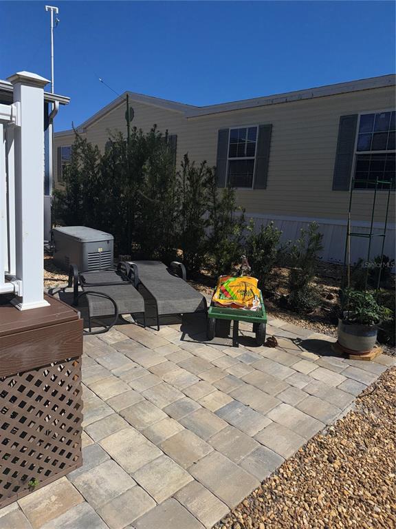 20732 South Grove Loop, Unit 630 Lutz, FL 33558 - Photo 26 of 28 a blue bench sitting in front of a house