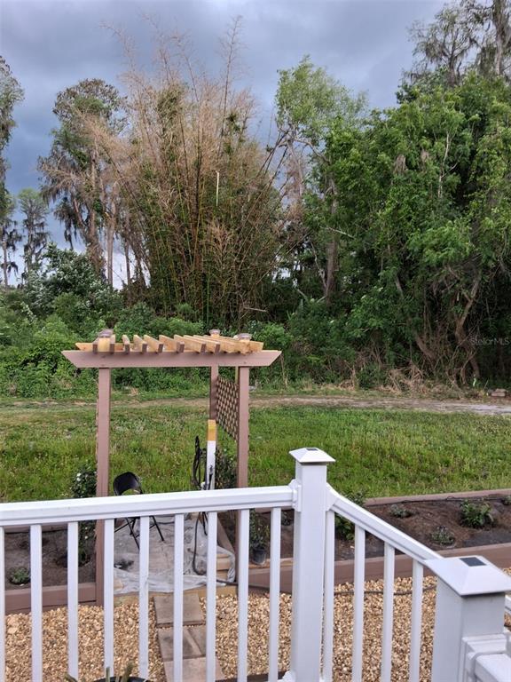 20732 South Grove Loop, Unit 630 Lutz, FL 33558 - Photo 27 of 28 a view of a wooden deck and a yard