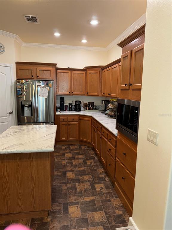 20732 South Grove Loop, Unit 630 Lutz, FL 33558 - Photo 10 of 28 a large kitchen with stainless steel appliances granite countertop a stove a sink dishwasher and a refrigerator