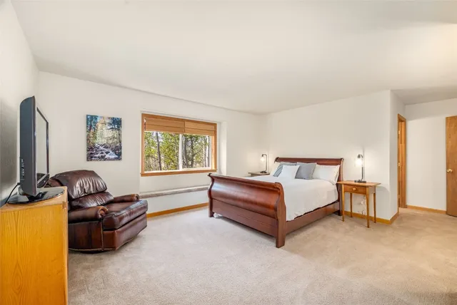 a spacious bedroom with a bed and a couch