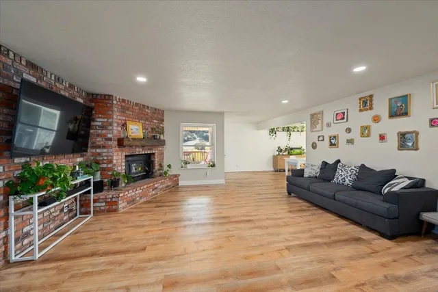 a living room with furniture a flat screen tv and a fireplace