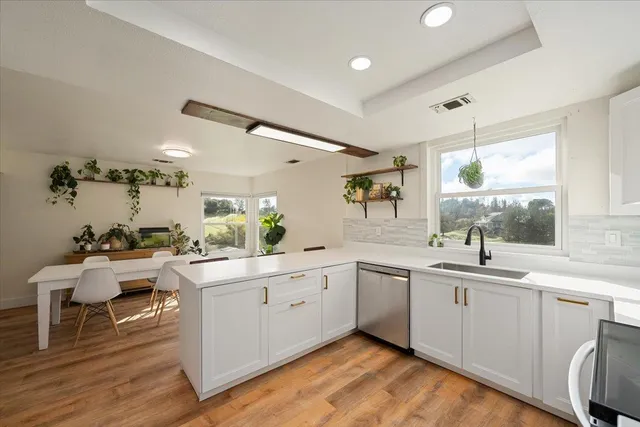 a kitchen with white cabinets sink and white appliances