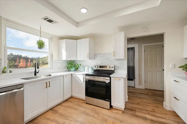 a kitchen with a sink stove and cabinets