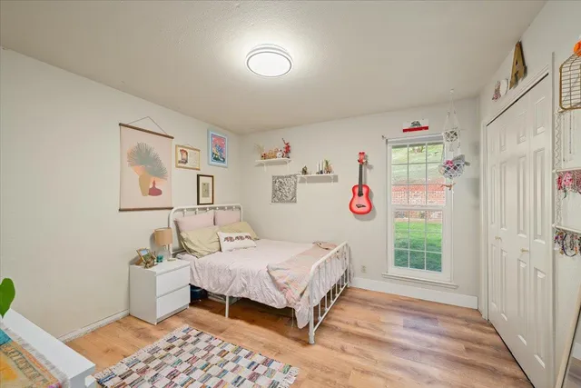 a bedroom with a bed and a window