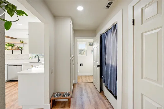 a view of walk in closet with wooden floor