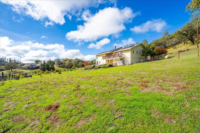 a view of a big yard with an outdoor space