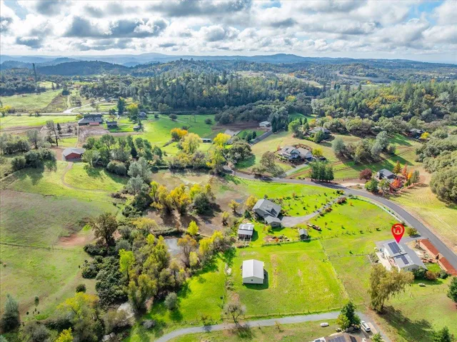 a view of a house with a yard and lake view