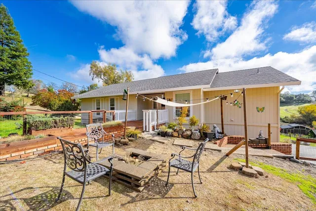 a view of a patio with table and chairs under an umbrella