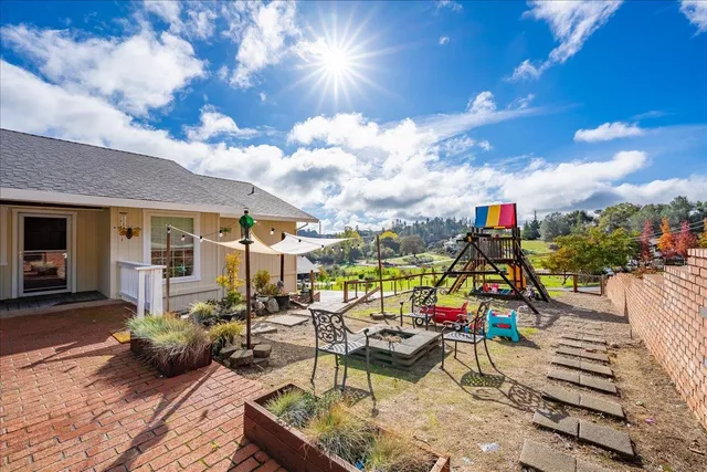 a view of a patio with table and chairs and potted plants