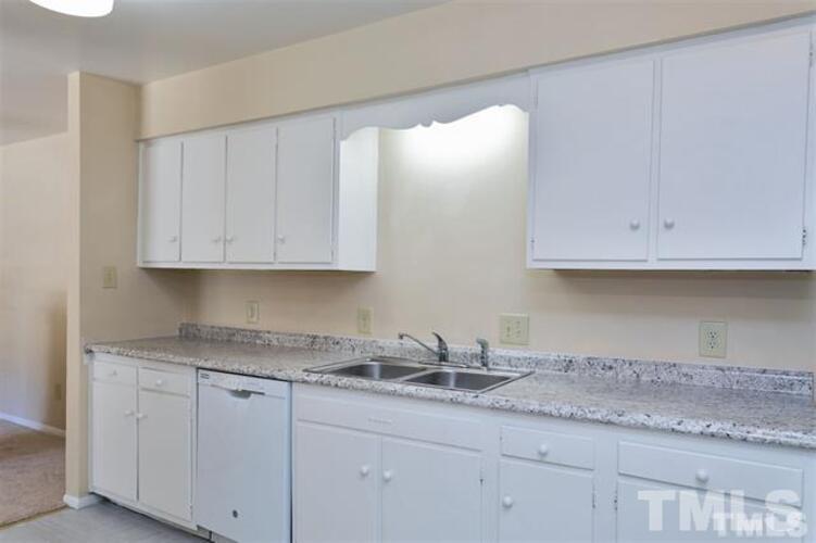 1022 Sandlin Place, Unit A Raleigh, NC 27606 - Photo 13 of 20 a kitchen with granite countertop white cabinets and a sink
