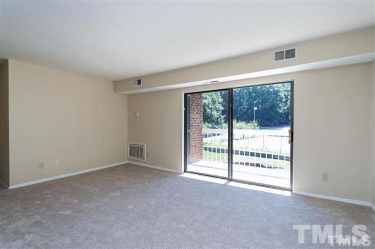1022 Sandlin Place, Unit A Raleigh, NC 27606 - Photo 14 of 20 a view of an empty room with a window