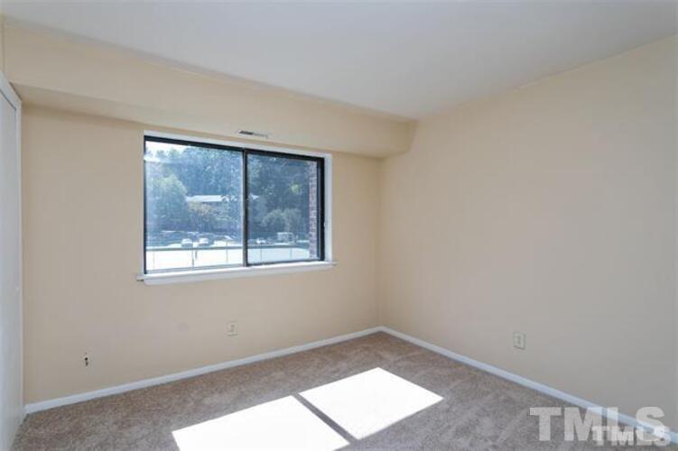 1022 Sandlin Place, Unit A Raleigh, NC 27606 - Photo 17 of 20 an empty room with a window
