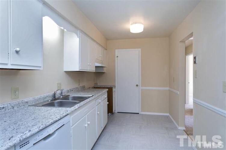 1022 Sandlin Place, Unit A Raleigh, NC 27606 - Photo 5 of 20 a kitchen that has a sink and a stove