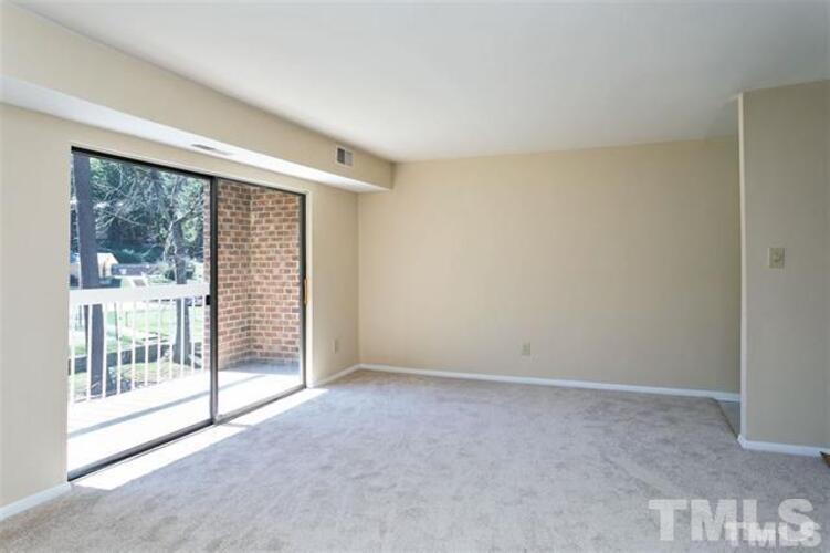 1022 Sandlin Place, Unit A Raleigh, NC 27606 - Photo 6 of 20 a view of an empty room with glass door